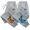 Pantalones deportivos estampados mariposa