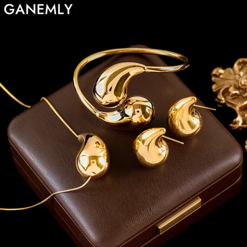 Conjunto de collar, pulsera y pendientes GANEMLY de acero inoxidable 316L con color dorado y dije de gota de agua